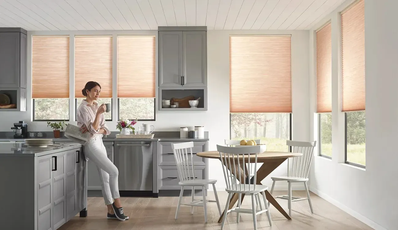 Applause cellular shades in warm tones on kitchen windows