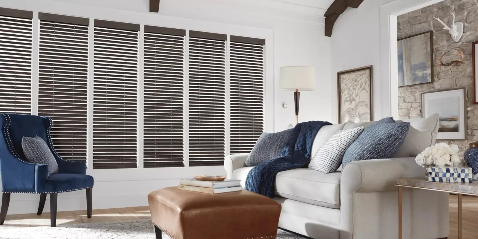 Parkland wood blinds in a living room with a stone fireplace