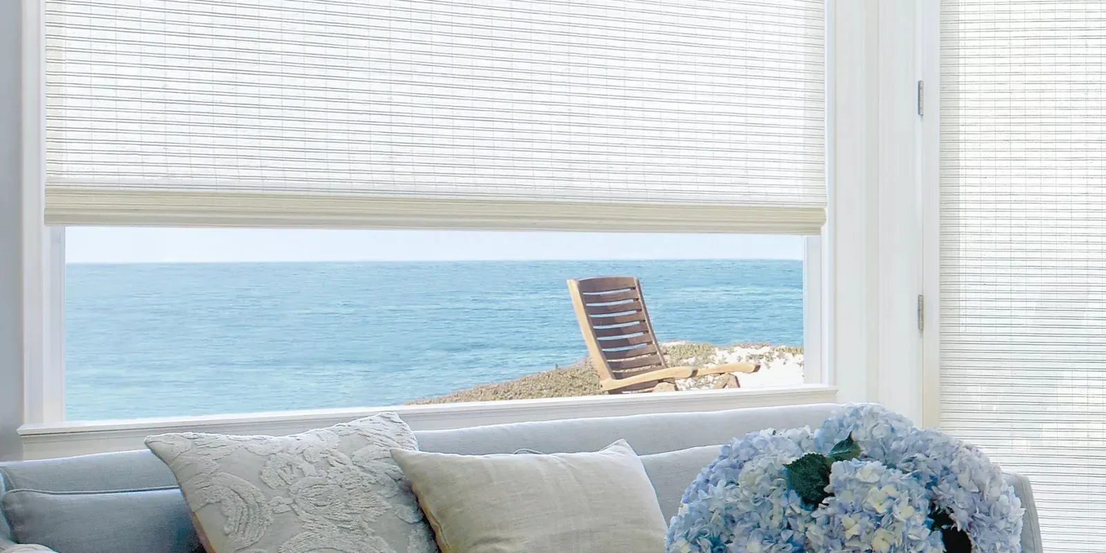 Provenance woven wood shades in a bright, coastal living room