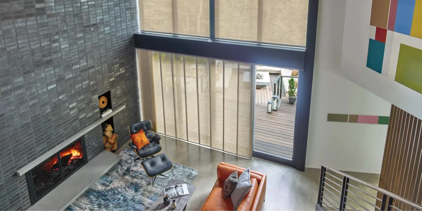 Skyline gliding panels on a tall window beside a fireplace
