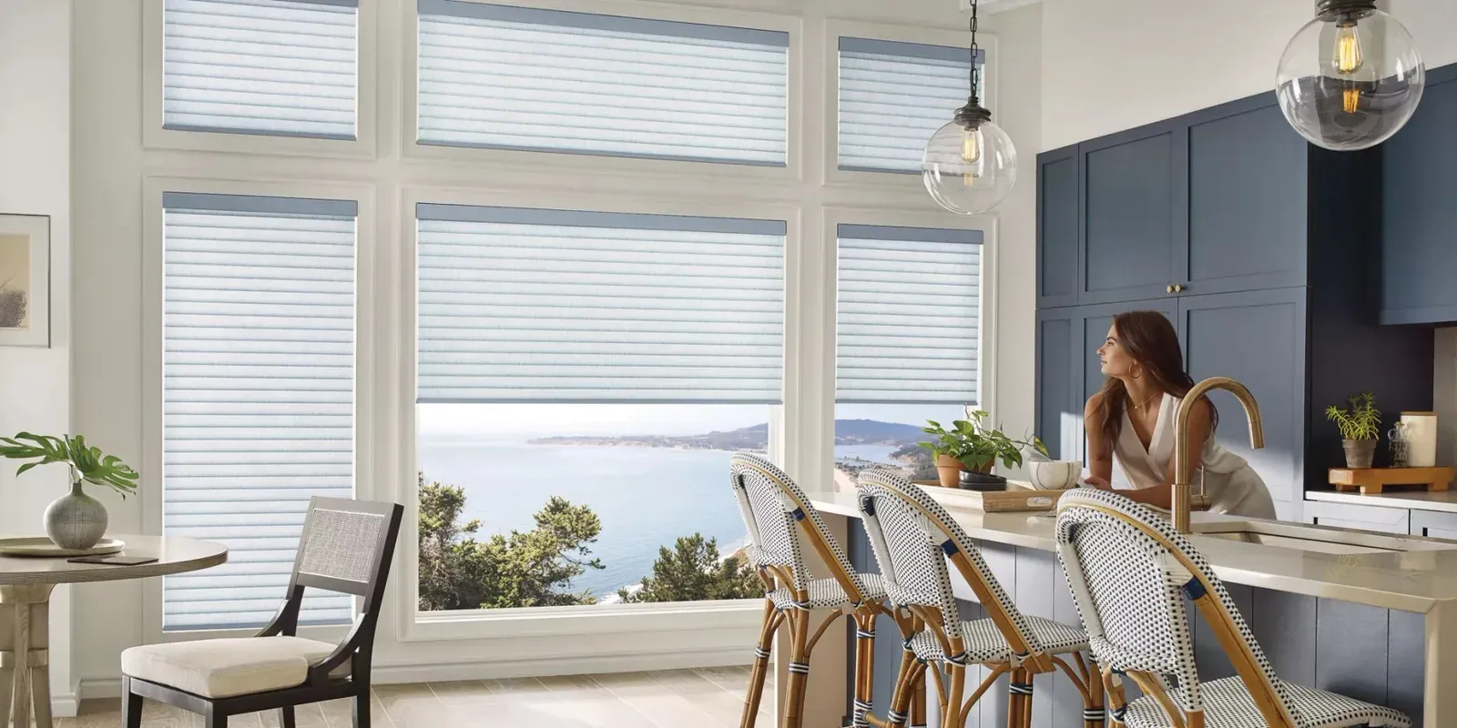 Sonnette cellular roller shades in a bright kitchen with water views