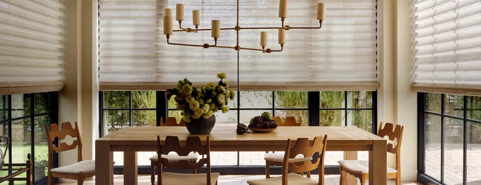 Vignette modern Roman shades above a dining table